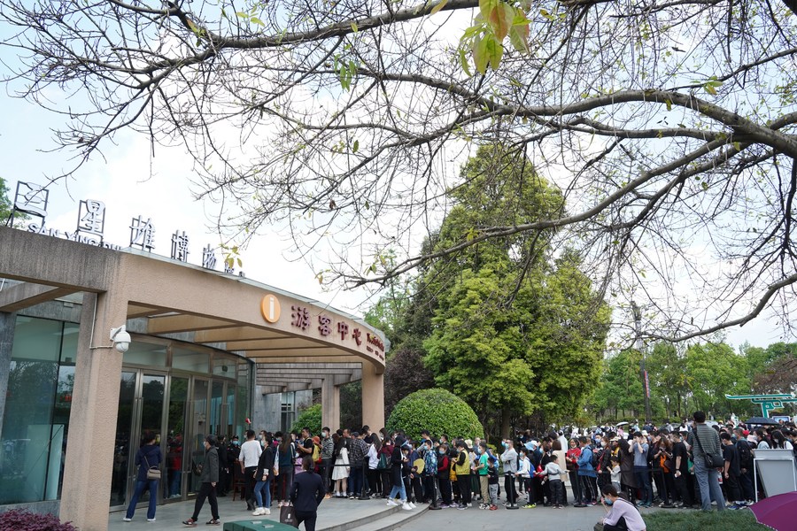 People wait to be admitted in front of the tourist service center at the Sanxingdui Museum in Guanghan City, southwest China's Sichuan Province. Photo by Xinhua/Liu Mengqi.