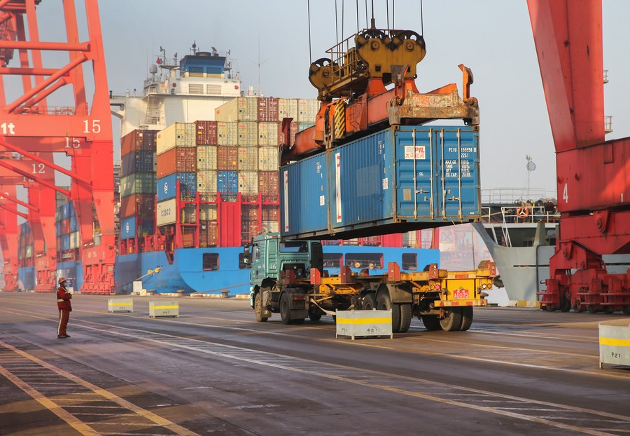 Cargos are unloaded from a container ship at the container terminal of the Lianyungang Port in Lianyungang City, east China's Jiangsu Province. Photo by Xinhua/Wang Jianmin.