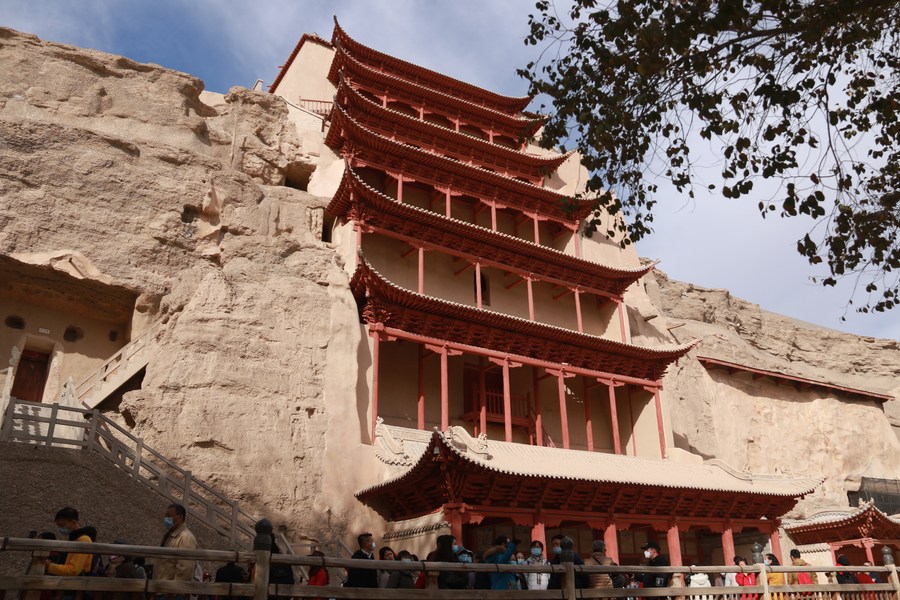 Tourists visit the Mogao Grottoes in Dunhuang, northwest China's Gansu Province Photo by Zhang Xiaoliang/Xinhua.