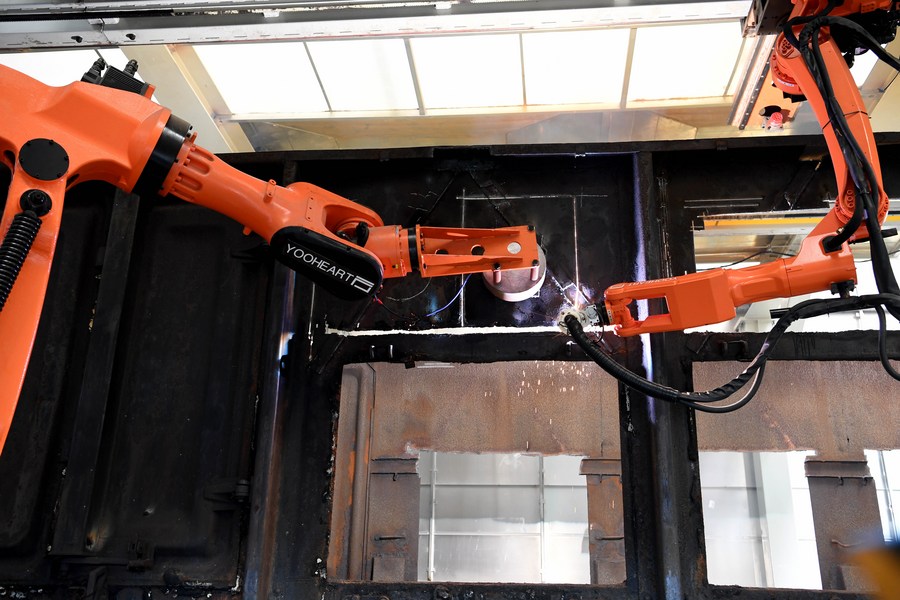 Robots dismantle automatically a scrap freight wagon at the intelligent production base for recycling railway materials in Ma'anshan, east China's Anhui Province. Photo by Xinhua/Liu Junxi.