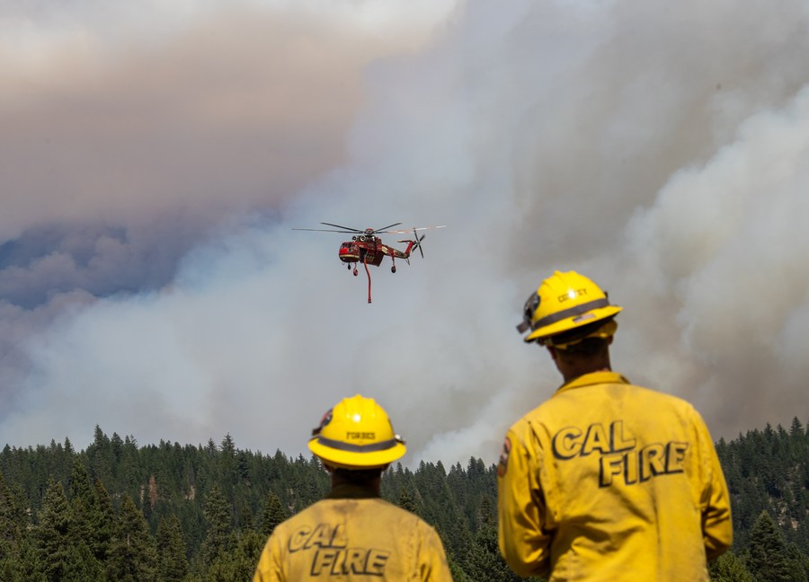 A helicopter flies to battle against a wildfire dubbed Dixie Fire in Lassen National Forest, Northern California, the United States. Photo by Dong Xudong/Xinhua.