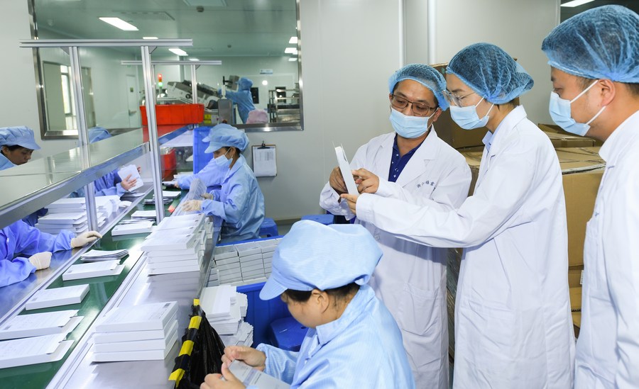 Head of a biotech company (3rd R) introduces a cosmetics production line to a market regulator and a bank staff member for loan application in Huzhou City, east China's Zhejiang Province. Photo by Xinhua/Weng Xinyang.