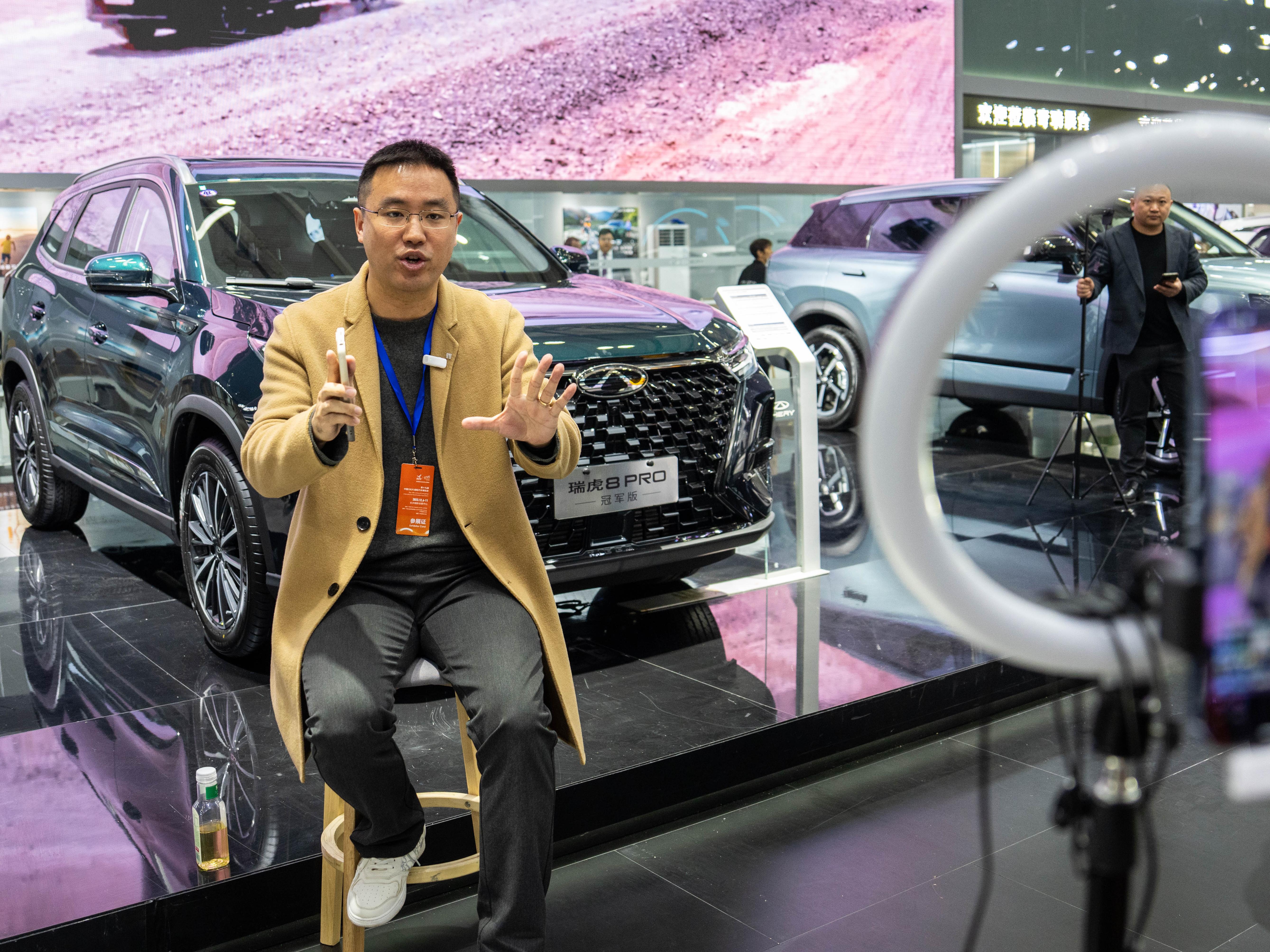 A man performs livestreaming during an automobile exposition at the Changsha International Convention and Exhibition Center in Changsha, central China's Hunan Province. Photo by Xinhua/Chen Sihan.