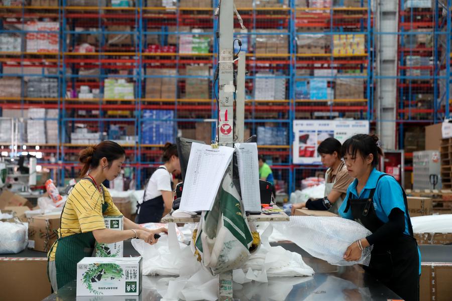 Workers work at a warehouse in Longli County, southwest China's Guizhou Province. Photo by Yuan Fuhong/Xinhua.